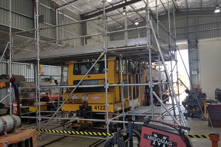 Scaffold access around a railway maintenance machine